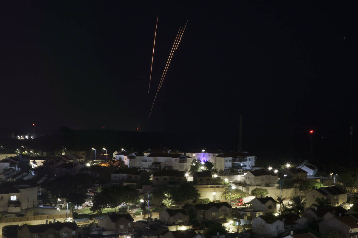 Rockets are fired toward Israel from the Gaza Strip as seen from southern Israel, Saturday, Dec ...