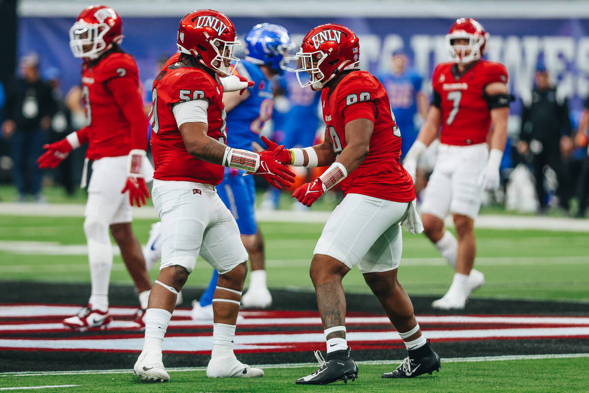 UNLV defensive lineman Jalen Dixon (50) celebrates a stop with UNLV defensive lineman Keith Con ...