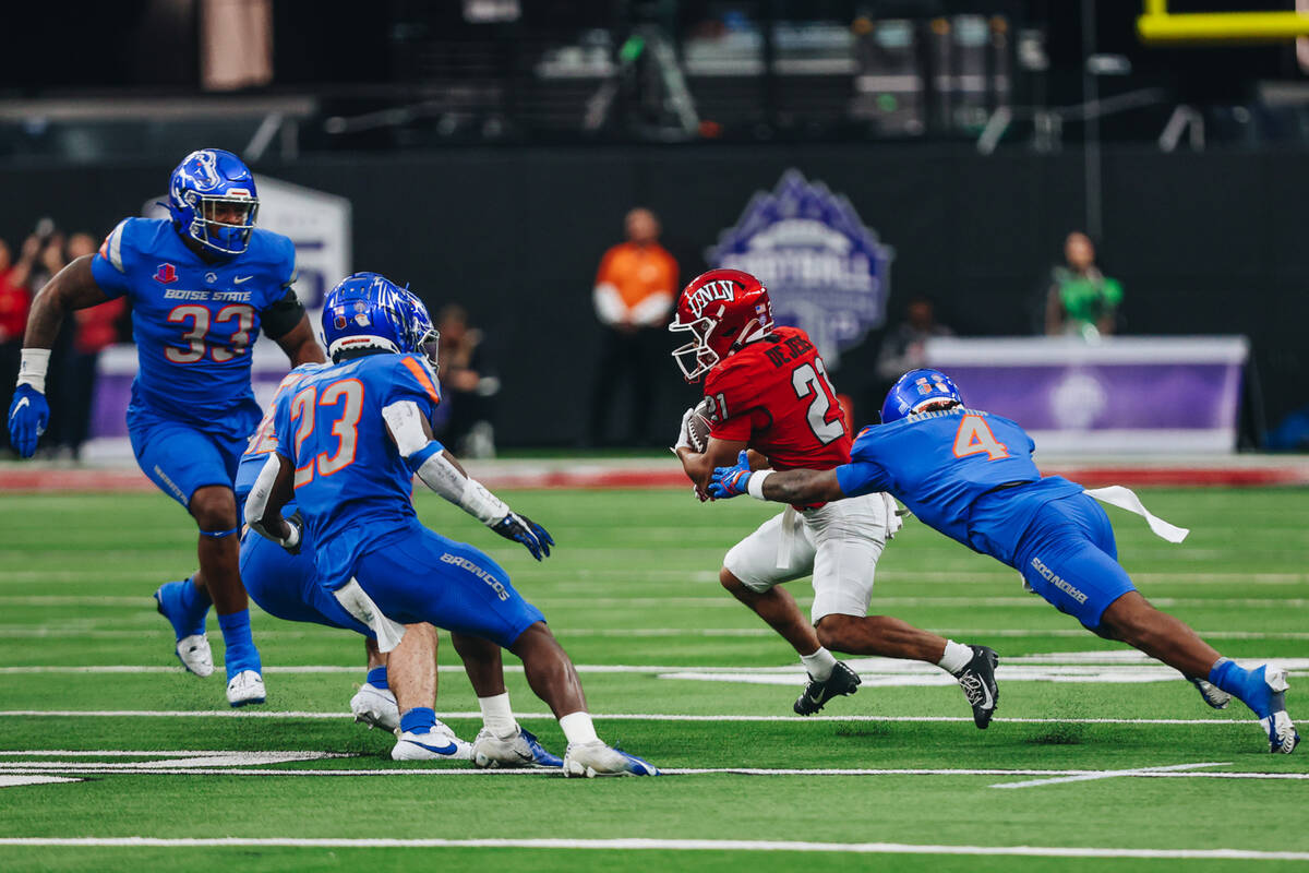 UNLV wide receiver Jacob De Jesus (21) carries the ball as Boise State safety Rodney Robinson ( ...