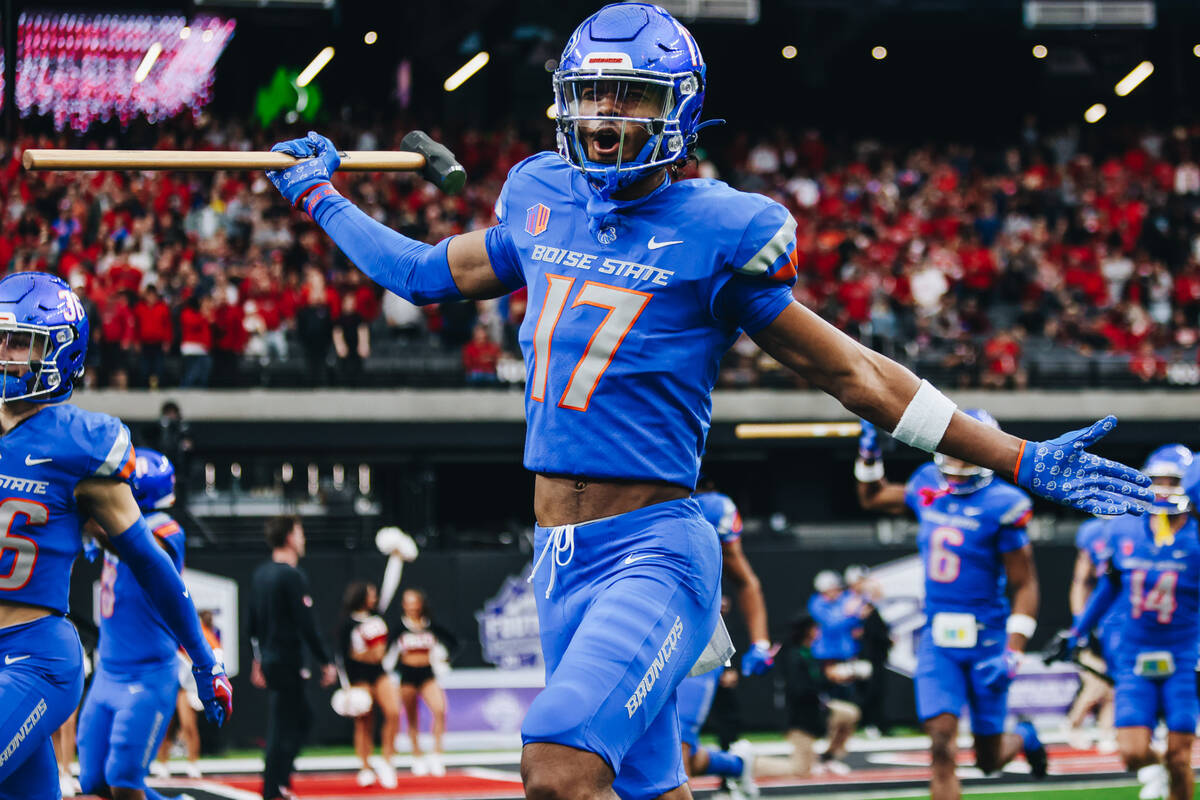 Boise State wide receiver Prince Strachan (17) runs out of the tunnel with a hammer before the ...