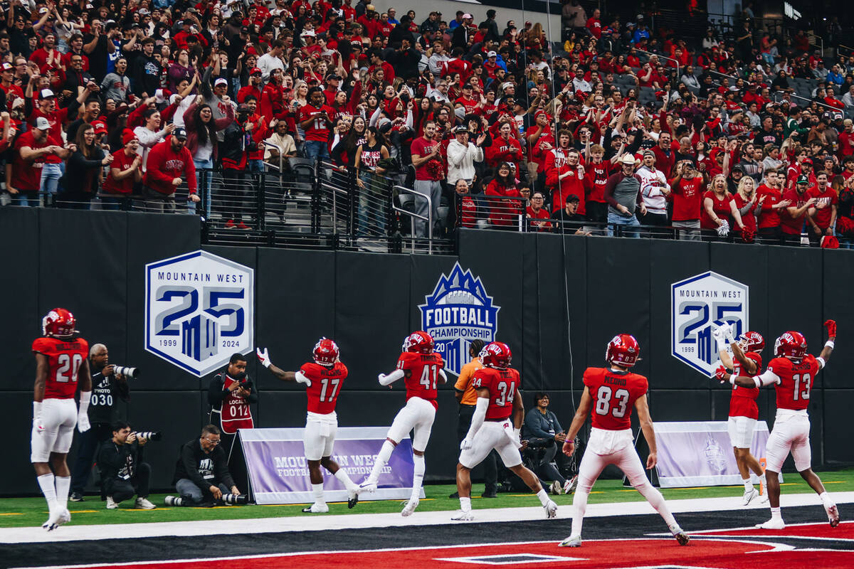UNLV players pump up their fans during the Mountain West championship game at Allegiant Stadium ...