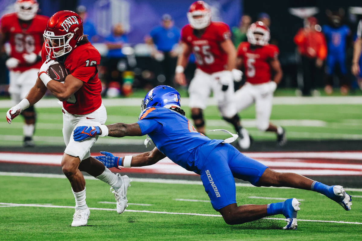 UNLV wide receiver DeAngelo Irvin Jr. (16) runs with the ball as Boise State safety Rodney Robi ...