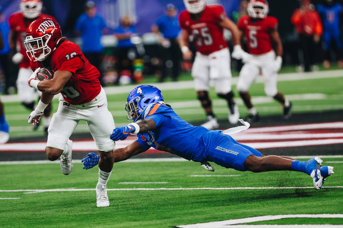 UNLV wide receiver DeAngelo Irvin Jr. (16) runs with the ball as Boise State safety Rodney Robi ...