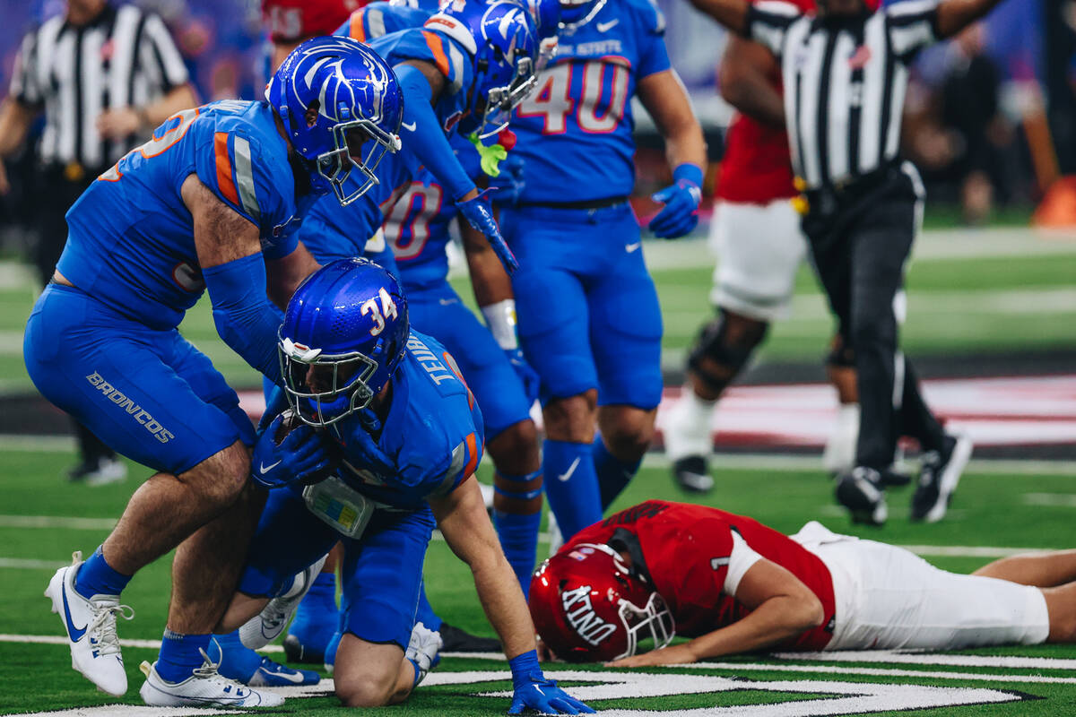 Boise State safety Alexander Teubner (34) gets up with the ball after recovering a fumble by UN ...