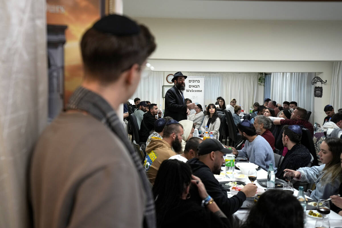 Cyprus' Chief Rabbi Arie Zeev Raskin, background, addresses young people who attended a retreat ...