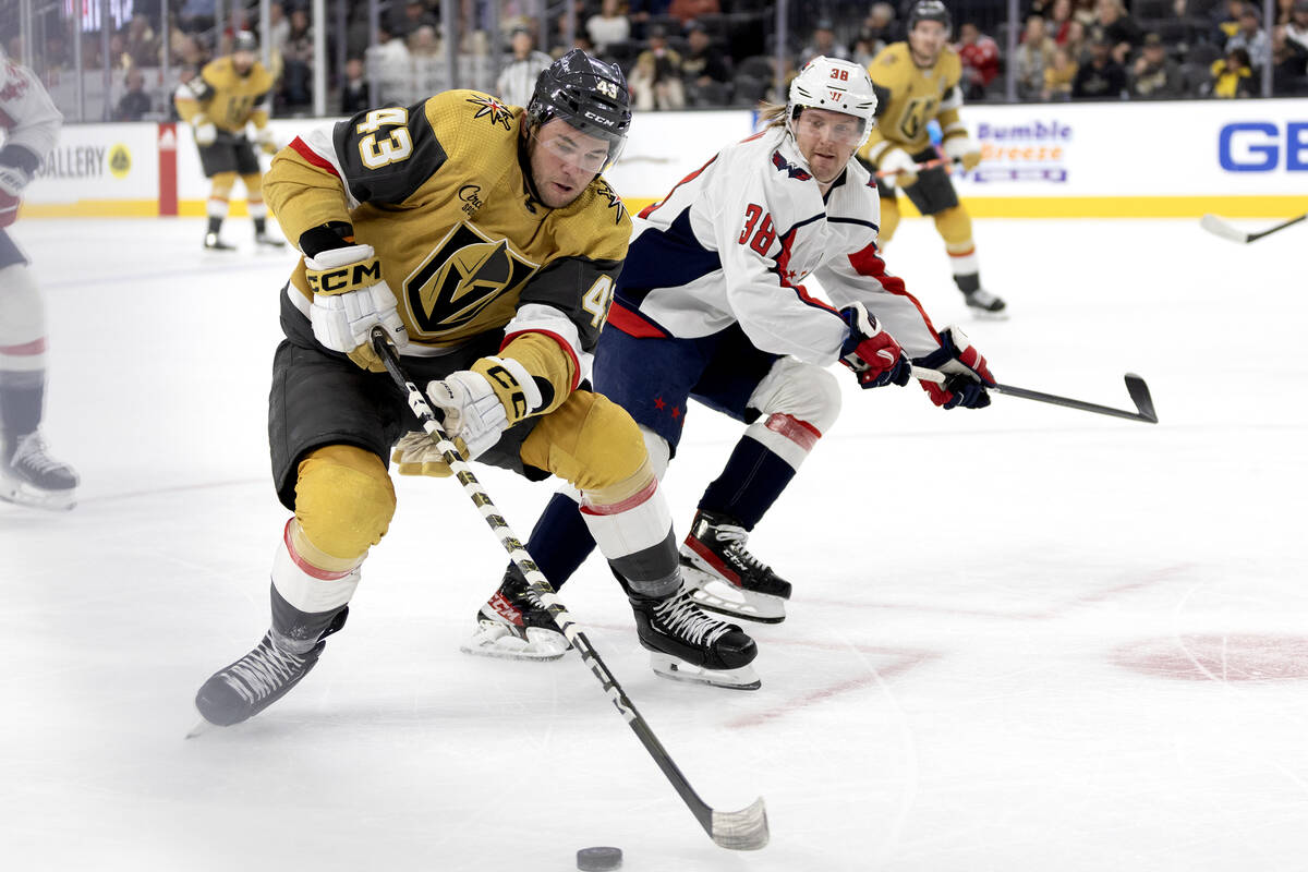 Golden Knights center Paul Cotter (43) skates with the puck against Capitals defenseman Rasmus ...