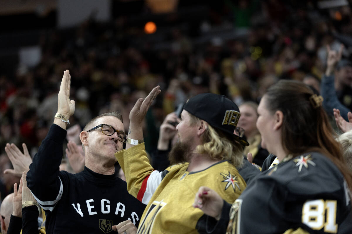 Golden Knights fans celebrate a goal during the second period of an NHL hockey game against the ...