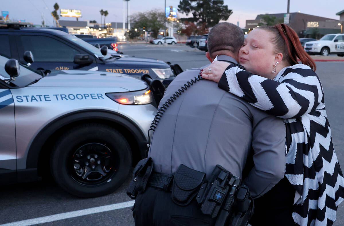 Amanda Douglas, who works for Quality Towing and Nevada Highway Patrol Sgt. Jason Buratczuk hug ...