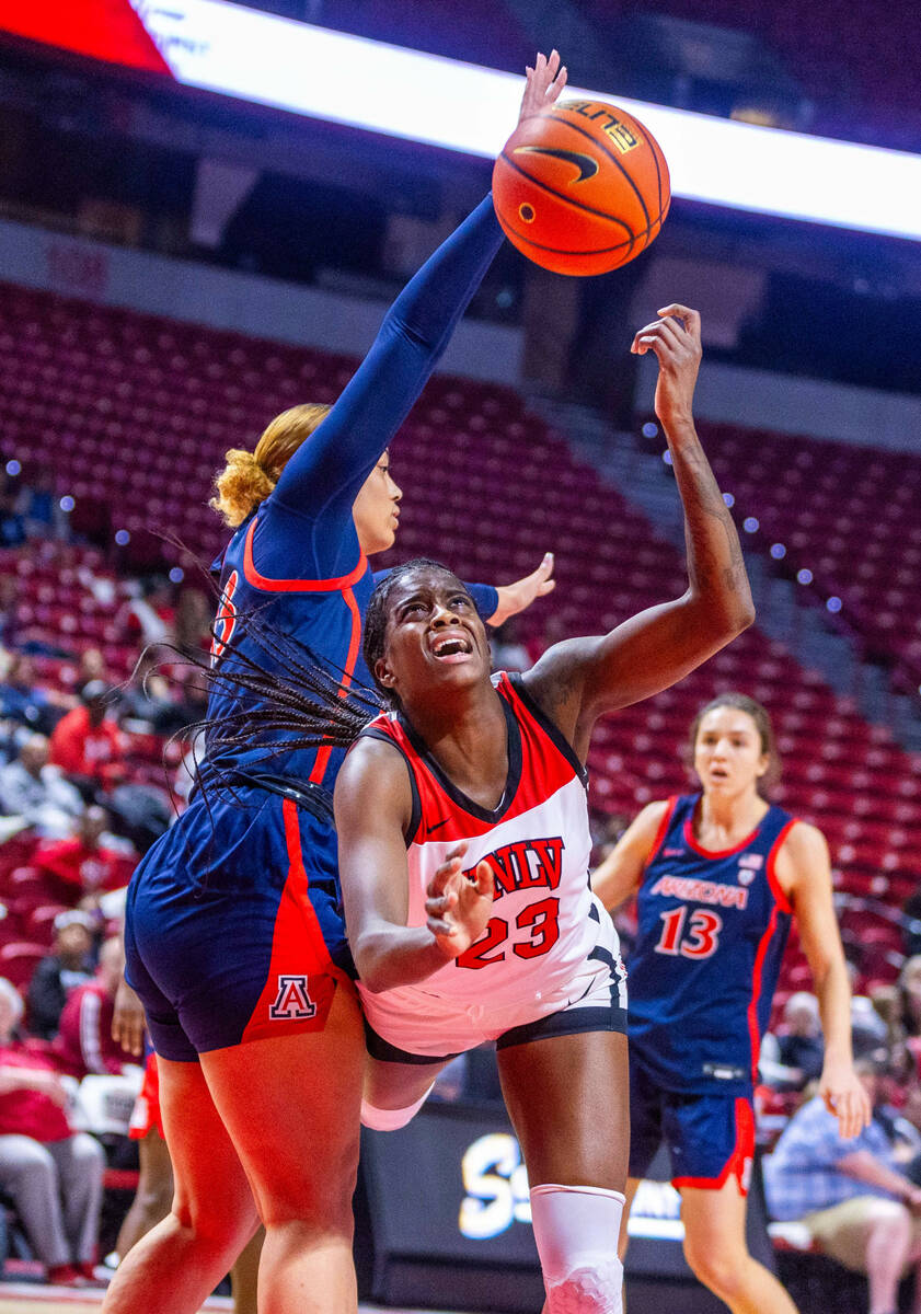 UNLV Lady Rebels center Desi-Rae Young (23) is fouled from behind by Arizona Wildcats forward I ...