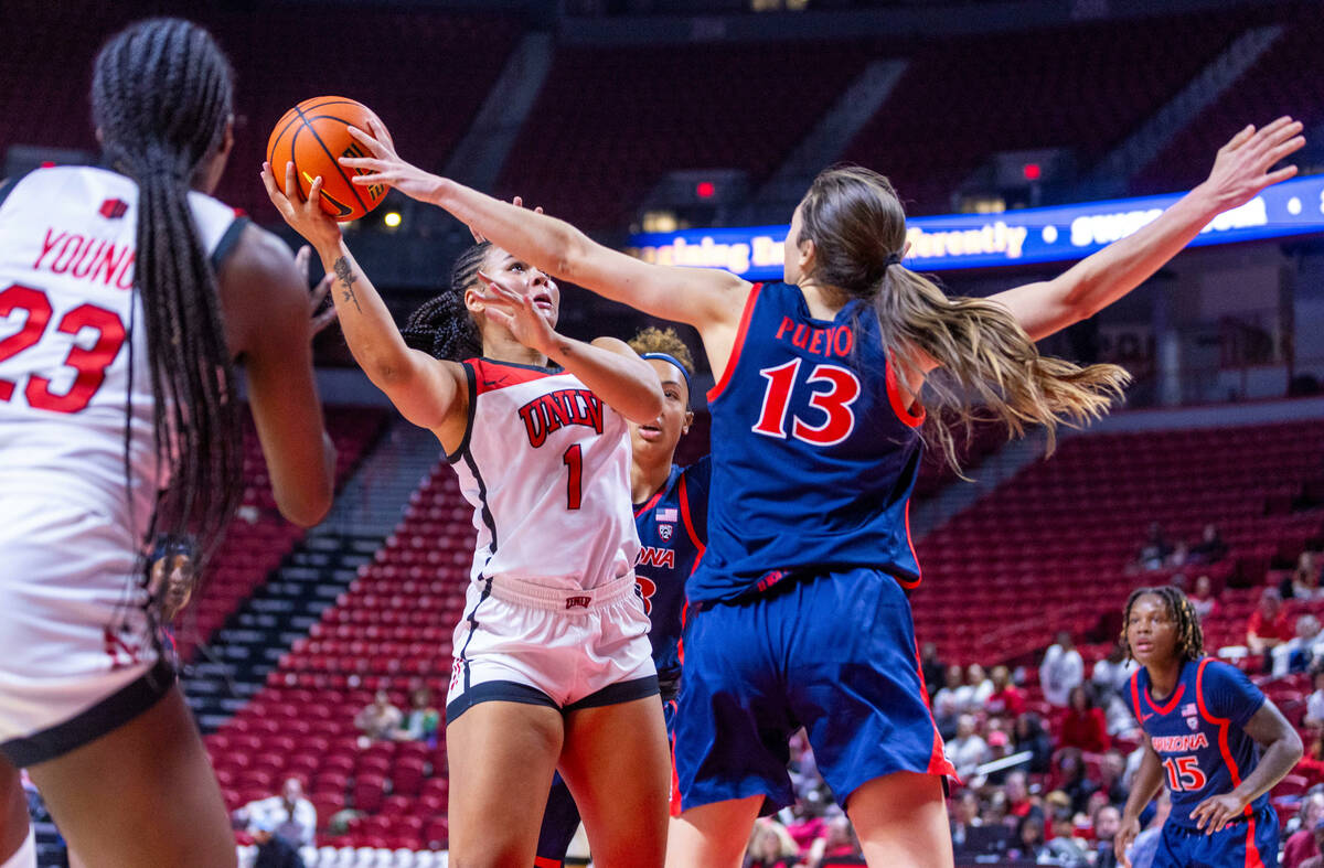UNLV Lady Rebels forward Nneka Obiazor (1)has a shot blocked by Arizona Wildcats guard Helena P ...