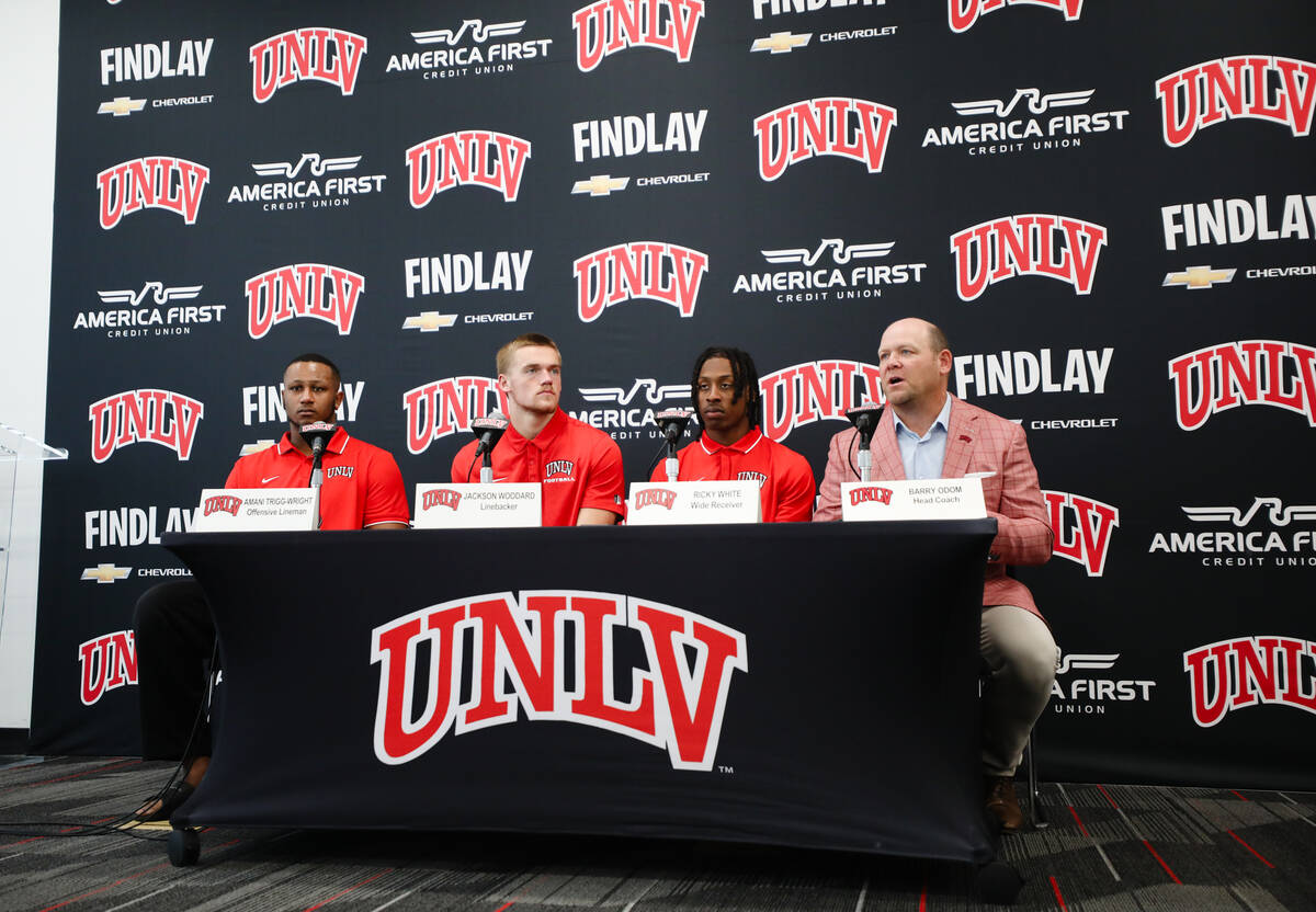 UNLV head coach Barry Odom, from right, addresses media next to wide receiver Ricky Wright, lin ...