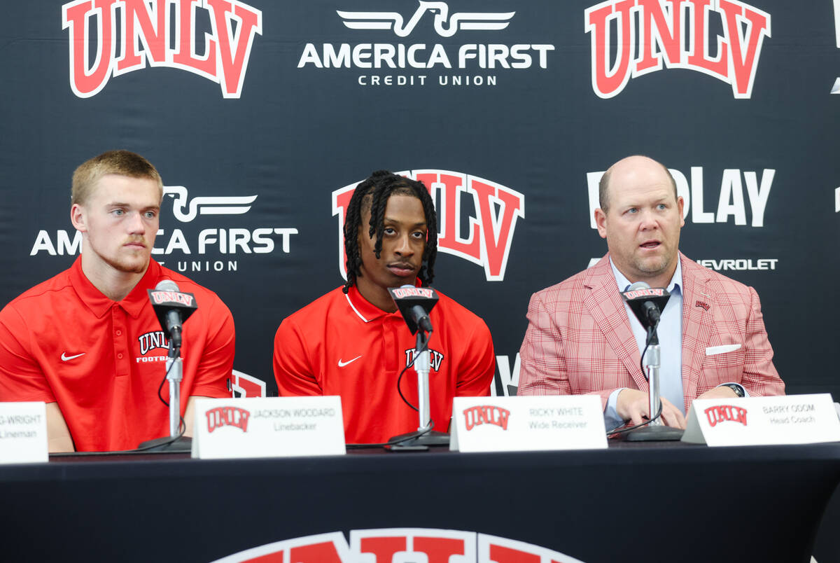 UNLV head coach Barry Odom, right, next to wide receiver Ricky White, center, and linebacker Ja ...