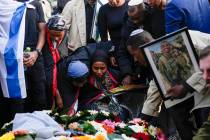 Family and friends of Staff Sergeant Aschalwu Sama mourn over his grave during his funeral in P ...