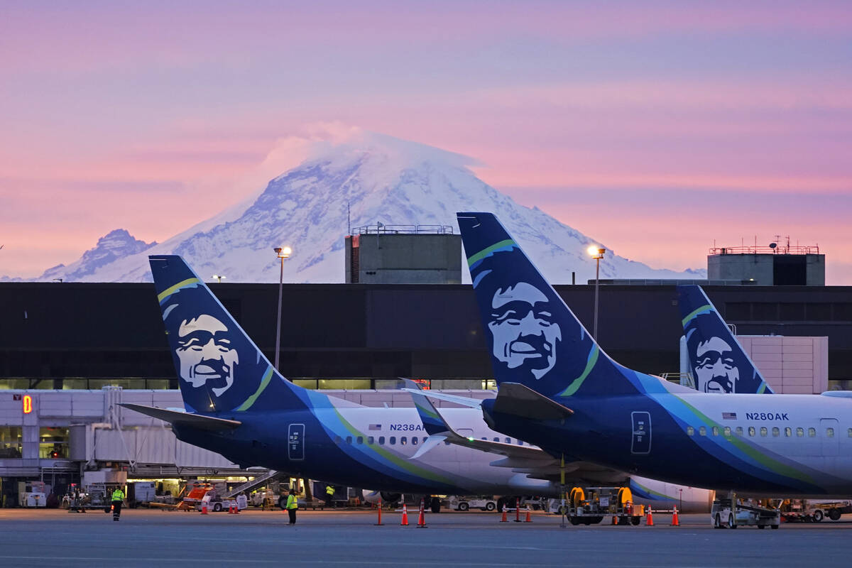 FILE - Alaska Airlines planes are shown parked at gates with Mount Rainier in the background at ...