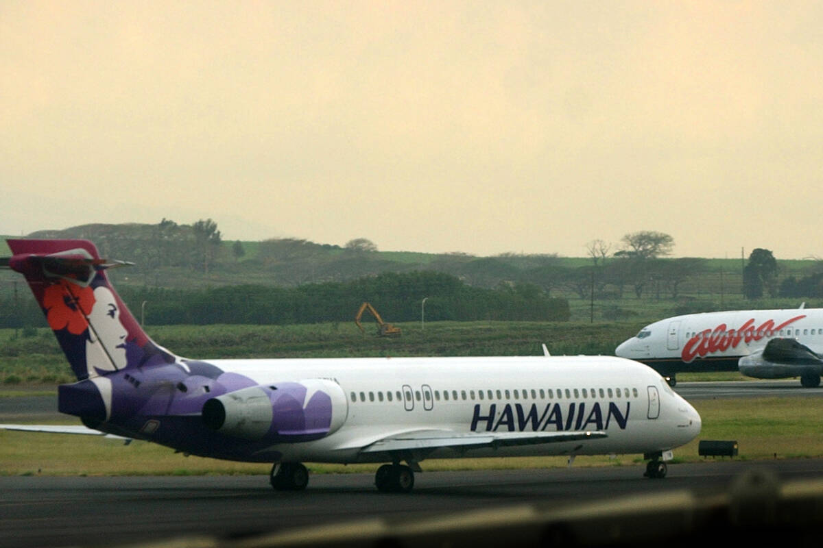 FILE - An Hawaiian Airlines plane taxis for position at Kahalui, Hawaii, on the island of Maui, ...