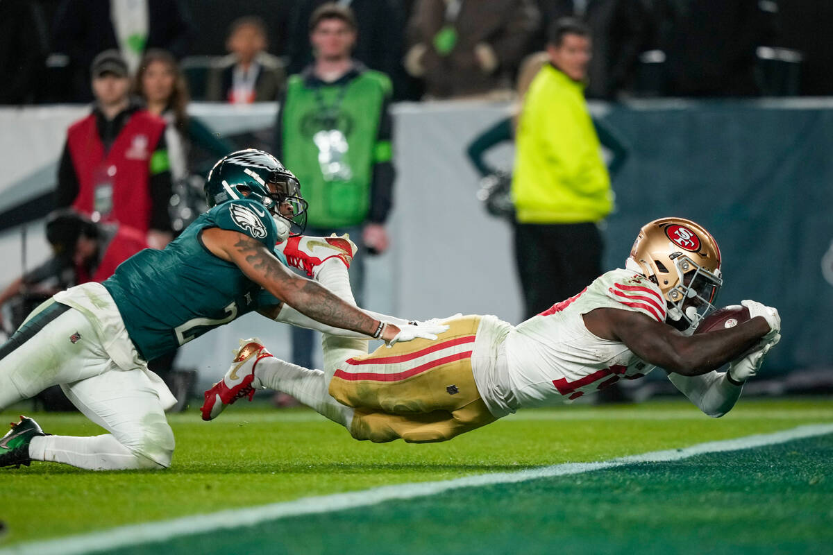 San Francisco 49ers wide receiver Deebo Samuel, right, dives in for a touchdown as Philadelphia ...