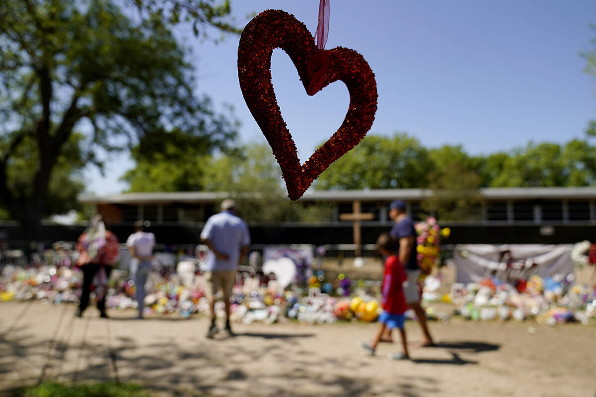 Visitors view a makeshift memorial honoring those recently killed at Robb Elementary School, Mo ...