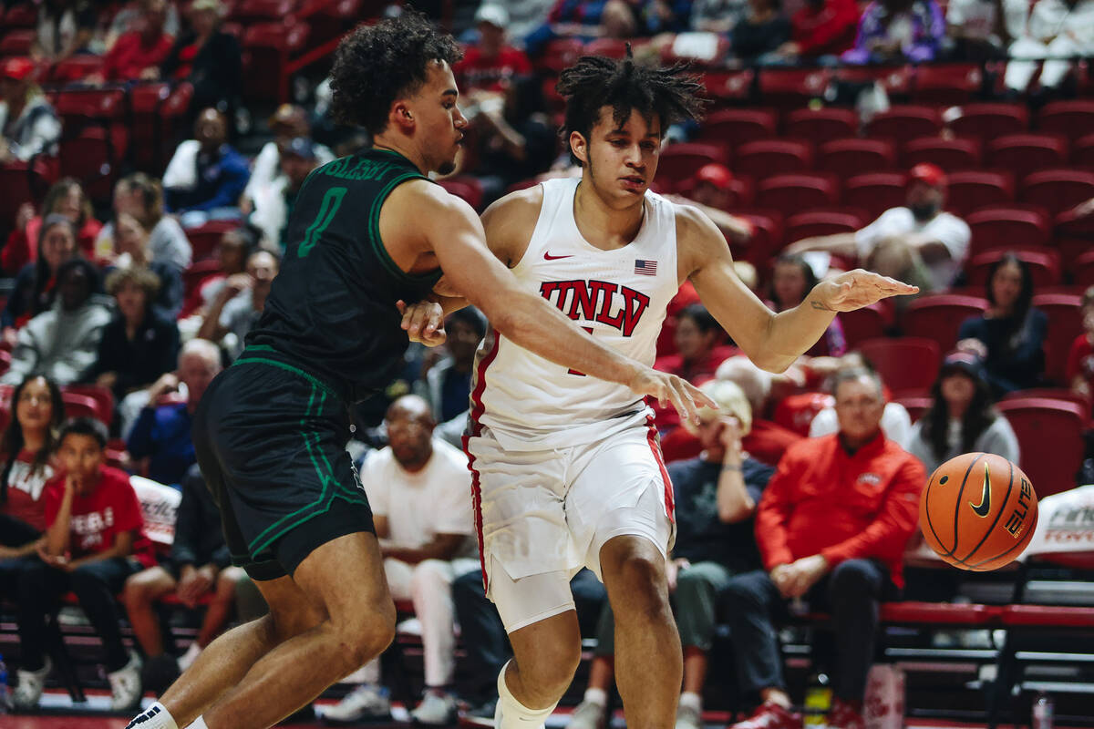 UNLV forward Jalen Hill (1) and Stetson guard Alec Oglesby (0) go in for the ball during a game ...