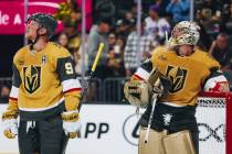 Golden Knights goaltender Logan Thompson (36) and Golden Knights center Jack Eichel (9) watch a ...