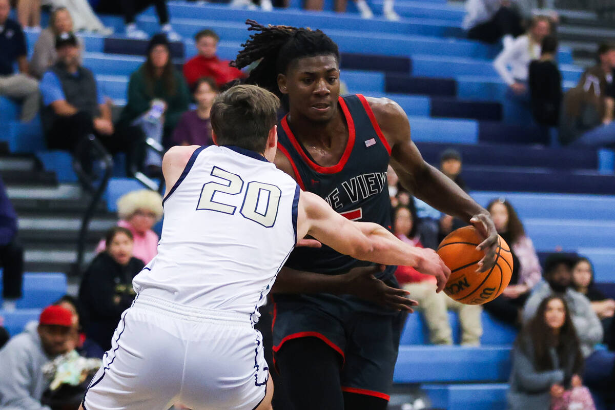 Arbor View’s Pharaoh Compton (5) moves the ball down the court during a basketball game ...