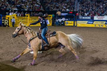 Hailey Kinsel of Cotulla, Texas., navigates a barrel on the way to her winning time in Barrel R ...