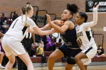 Spring Valley's high Mia Ervin (1) penetrates between Faith Lutheran's Sami Monighetti (1) and ...