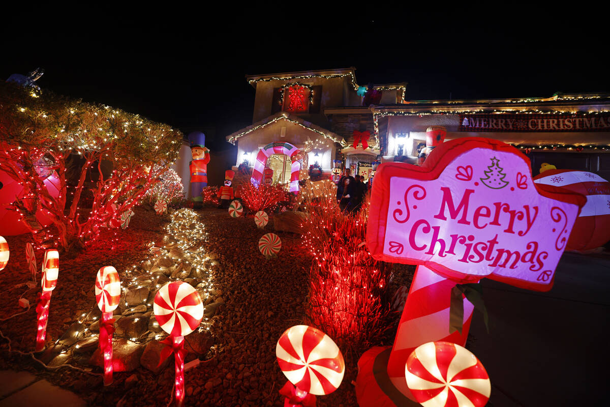 People visit the Candy Cane House on Dec. 16, 2022, in Henderson. Victor Cardenas and his husba ...