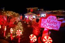 People visit the Candy Cane House on Dec. 16, 2022, in Henderson. Victor Cardenas and his husba ...