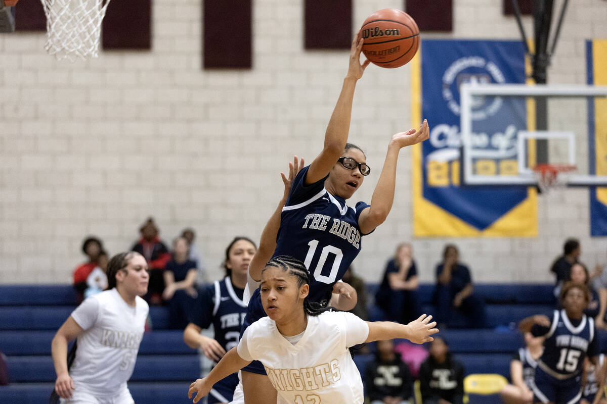Shadow Ridge’s Jasmyn Jefferson (10) passes instead of shooting with pressure from Democ ...