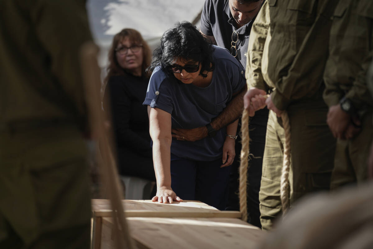 Mazal, mother of Israeli reservist Master Sgt. Gil Daniels who was killed in Gaza touches his c ...