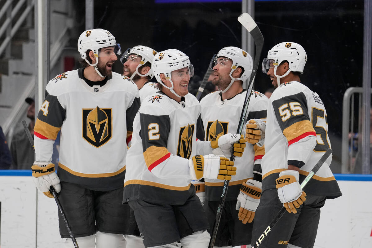Vegas Golden Knights' Zach Whitecloud (2) is congratulated by teammates after scoring during th ...