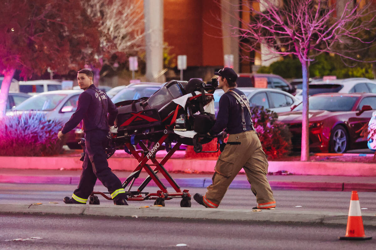 A gurney is pulled by emergency responders following a shooting on the UNLV campus on Wednesday ...