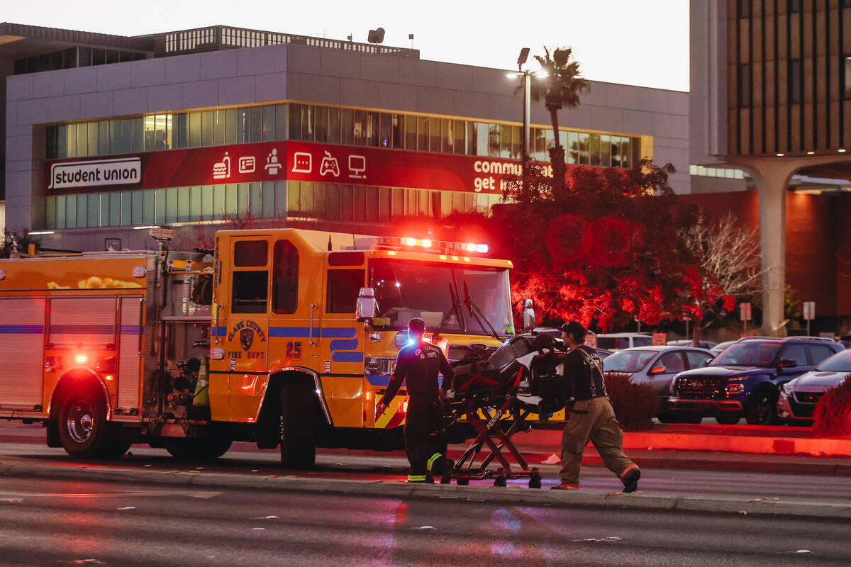 A gurney is pulled by emergency responders following a shooting on the UNLV campus on Wednesday ...