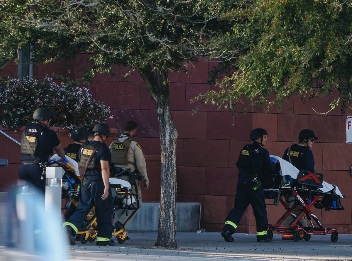 Gurney beds are brought to the scene of a shooting on the UNLV campus on Wednesday, Dec. 6, 202 ...
