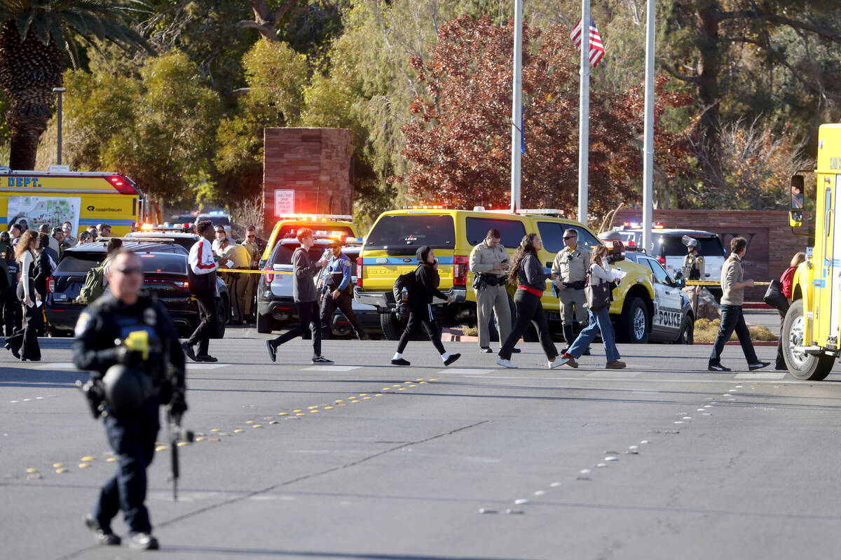 Police evacuate students on Harmon Avenue near Maryland Parkway after a shooting on the UNLV ca ...