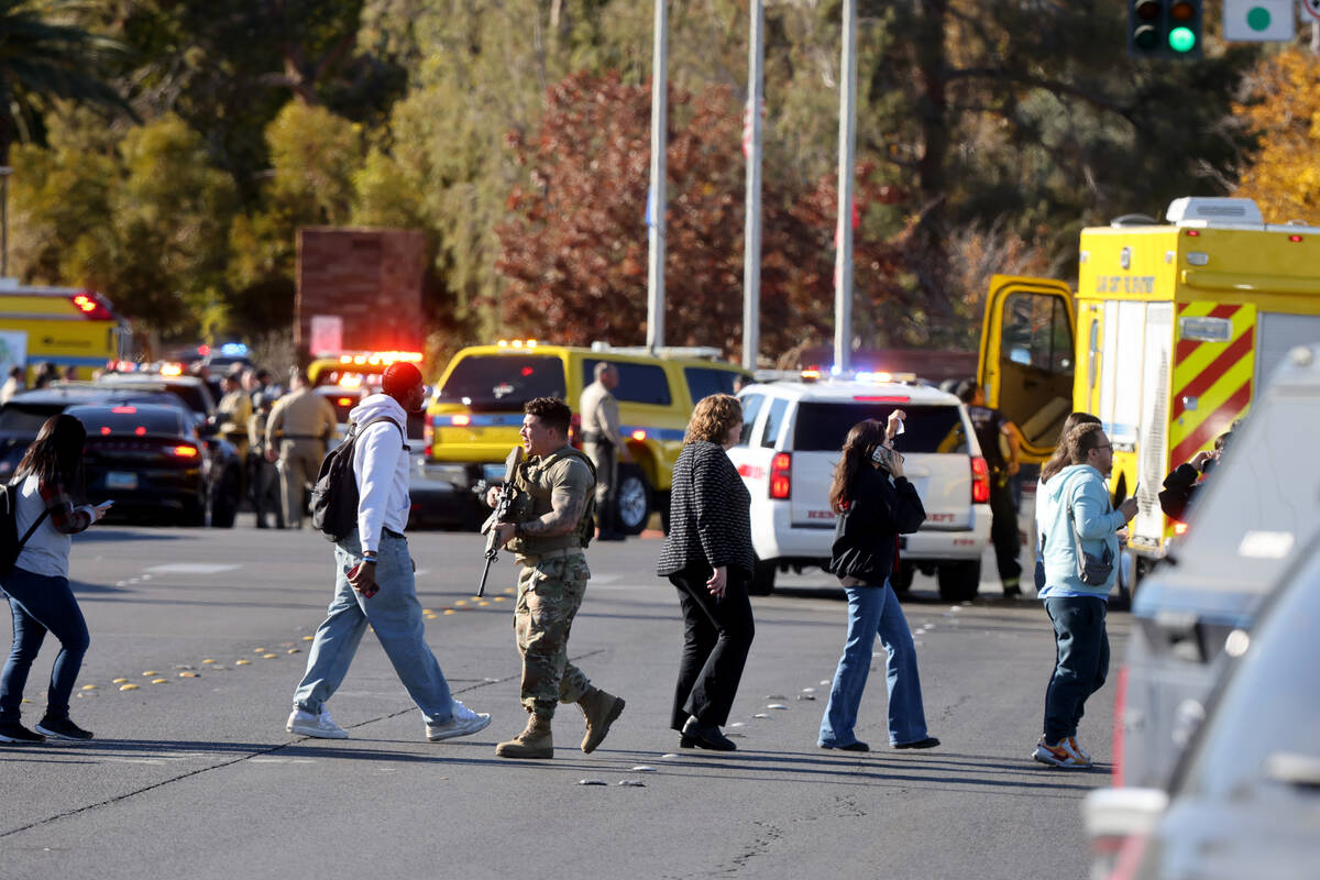 Police evacuate students on Harmon Avenue near Maryland Parkway after a shooting on the UNLV ca ...