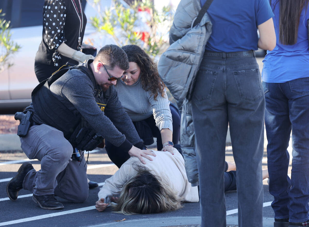 Police attend to a person near Maryland Parkway following a shooting on the UNLV campus in Las ...