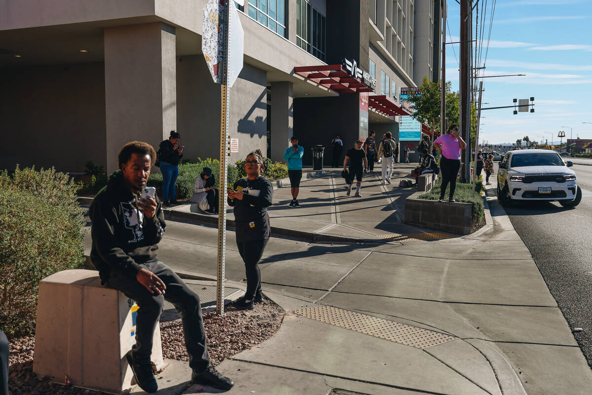 People take calls on the UNLV campus during a shooting on Wednesday, Dec. 6, 2023, in Las Vegas ...
