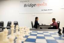 Julia Wang, 10, left, faces Timi Guo, 8, in a chess game before their lesson at Bridgeopolis on ...