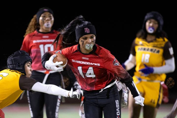 Desert Oasis’ Allie Peralta (14) runs the ball while Bonanza’s Larein Caballero ( ...