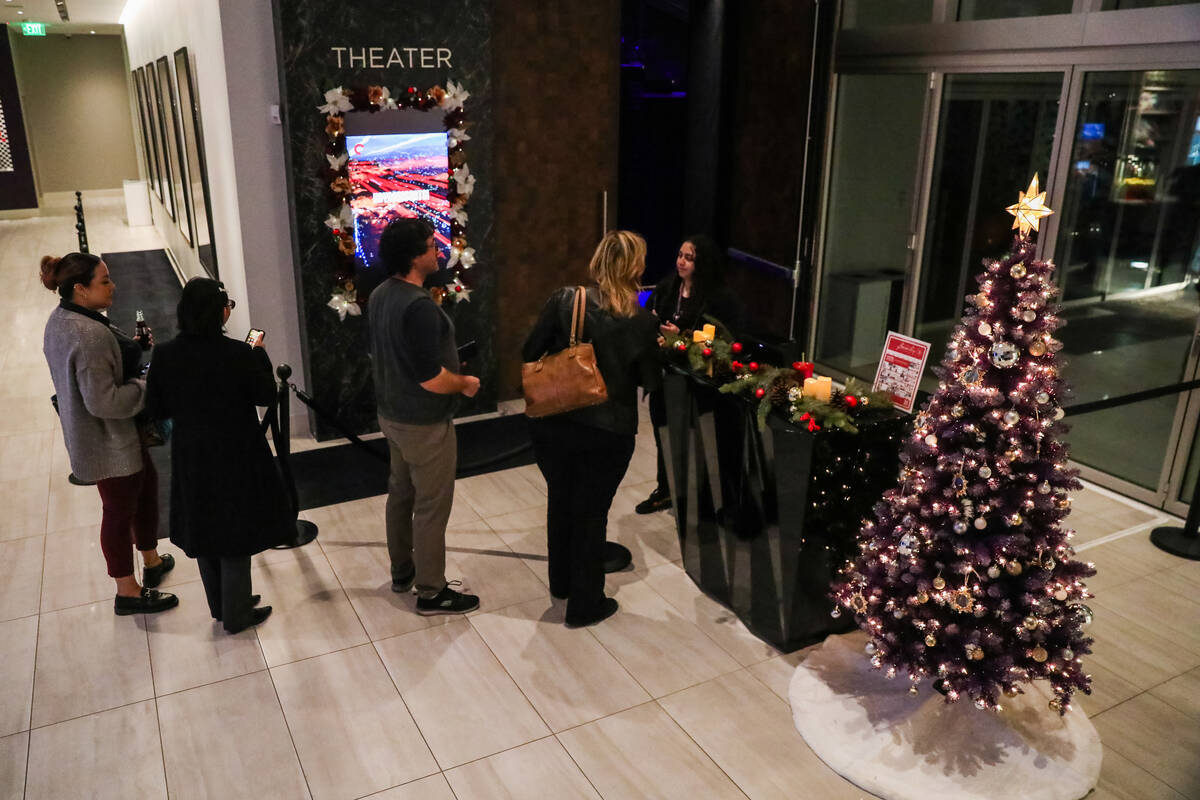 Belle Rivas, a production assistant at the Beverly Theater, helps guests check in for a movie o ...