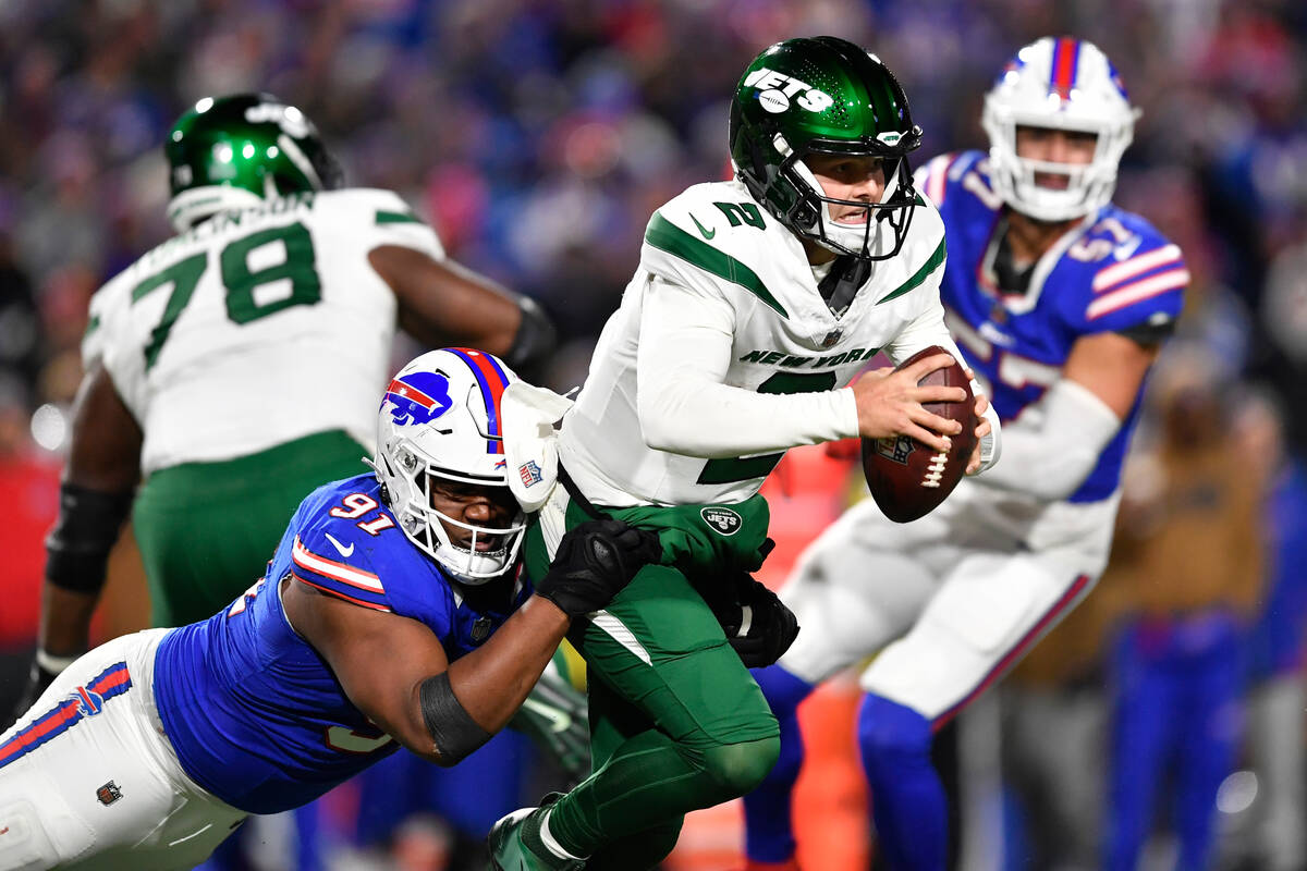 New York Jets quarterback Zach Wilson (2) is sacked by Buffalo Bills defensive tackle Ed Oliver ...