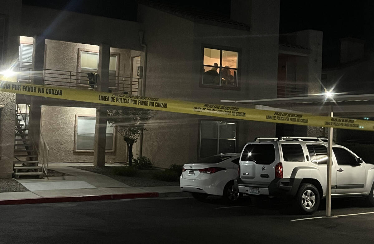 Law enforcement officers search an apartment at 360 North Arroyo Grande Parkway in Henderson on ...
