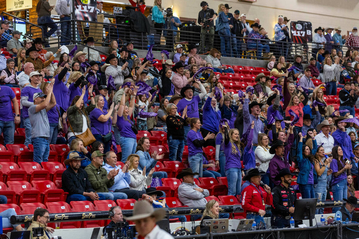 Fans applaud the competitors during the NFR breakaway roping challenge at South Point Arena on ...
