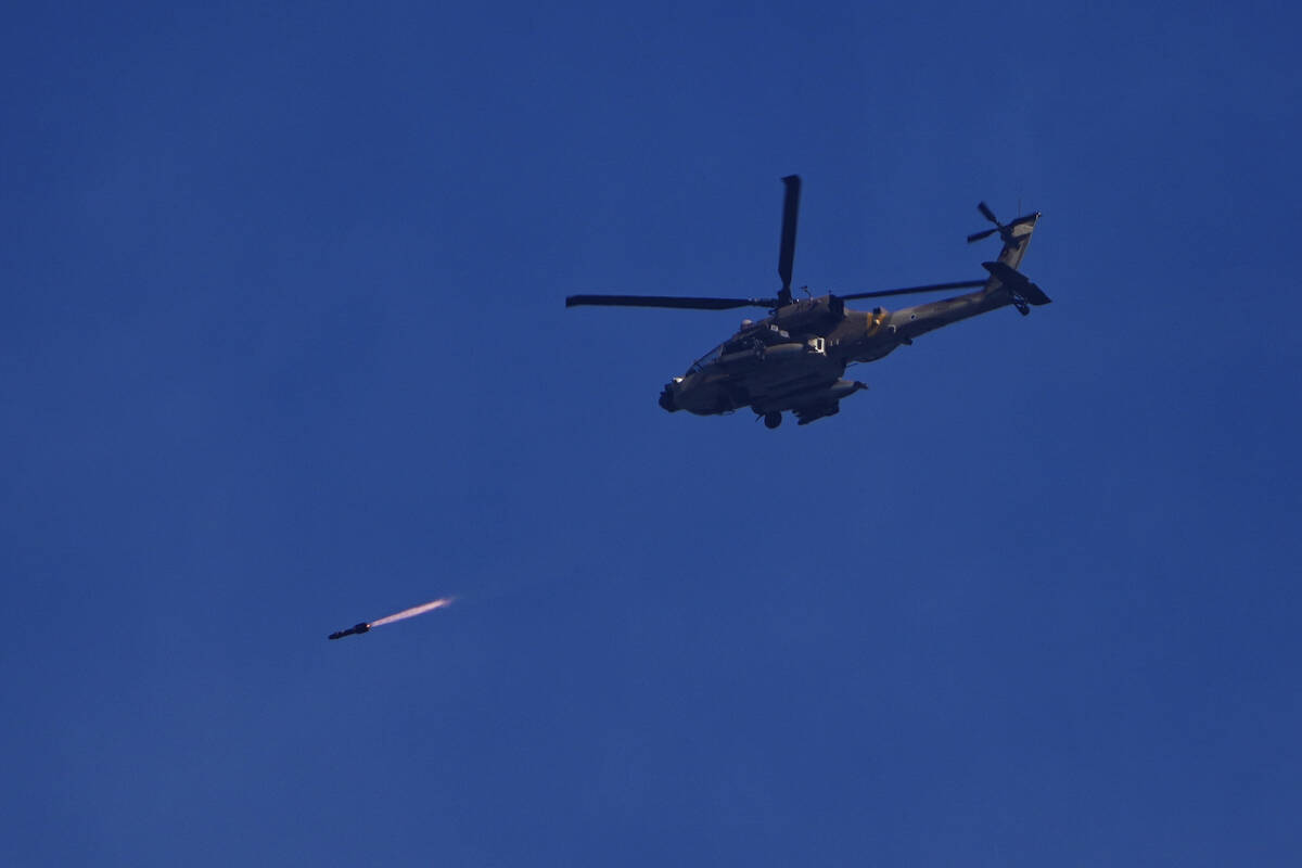 An Israeli Apache helicopter fires a missile in direction of the Gaza Strip, as seen from south ...