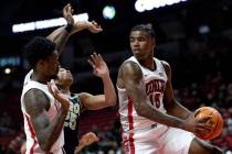 UNLV Rebels guard Luis Rodriguez (15) snags a rebound from Akron Zips forward Enrique Freeman ( ...