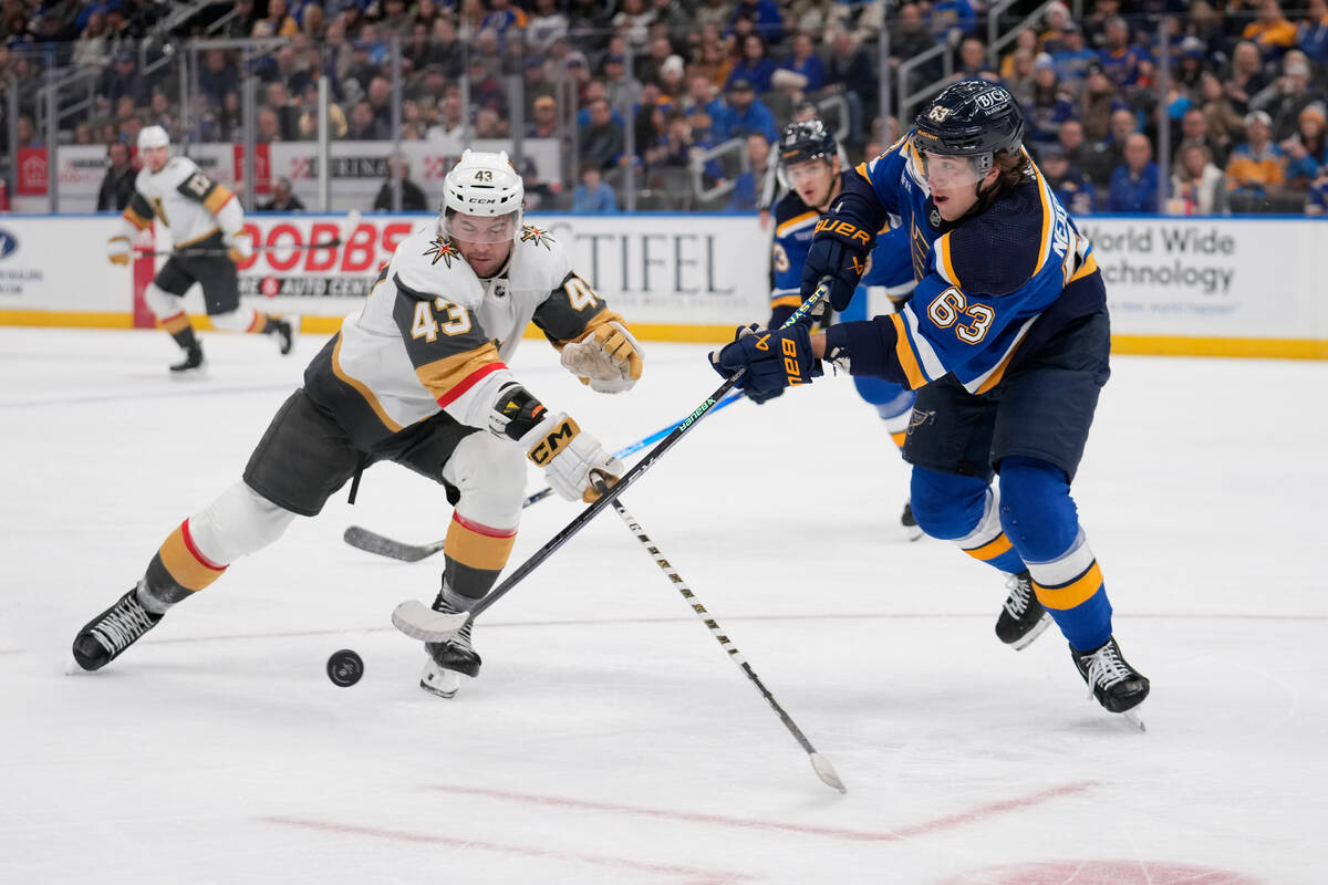 St. Louis Blues' Jake Neighbours (63) and Vegas Golden Knights' Paul Cotter (43) battle for a l ...