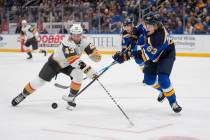 St. Louis Blues' Jake Neighbours (63) and Vegas Golden Knights' Paul Cotter (43) battle for a l ...