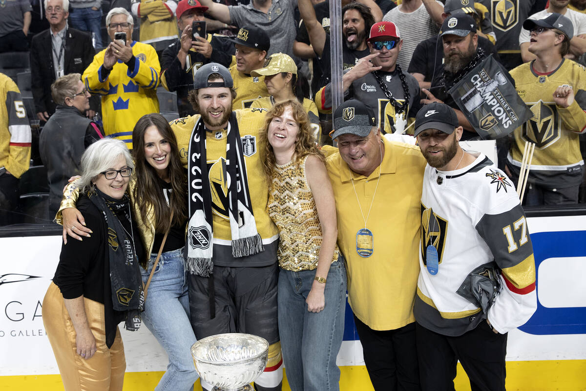 Golden Knights defenseman Ben Hutton (17) poses for a photo with his family and the Stanley Cup ...