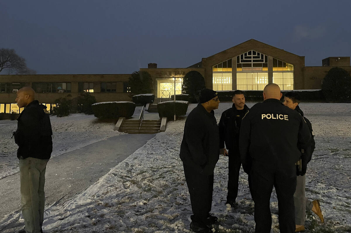 Albany police officers gather outside Temple Israel, Thursday, Dec. 7, 2023, in Albany, N.Y. A ...